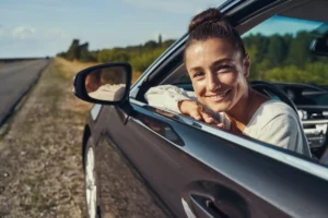 joyful-driver-looking-out-of-car-window